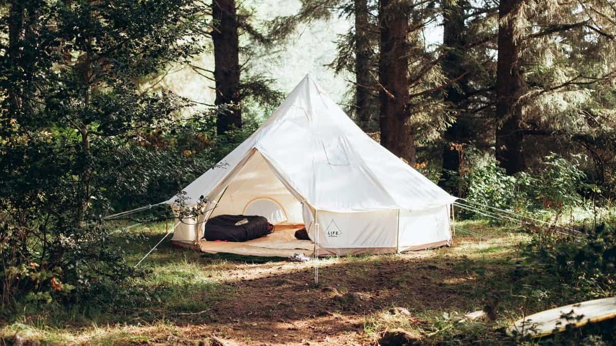 A glamping tent with a luxury down sleeping bag neatly arranged inside