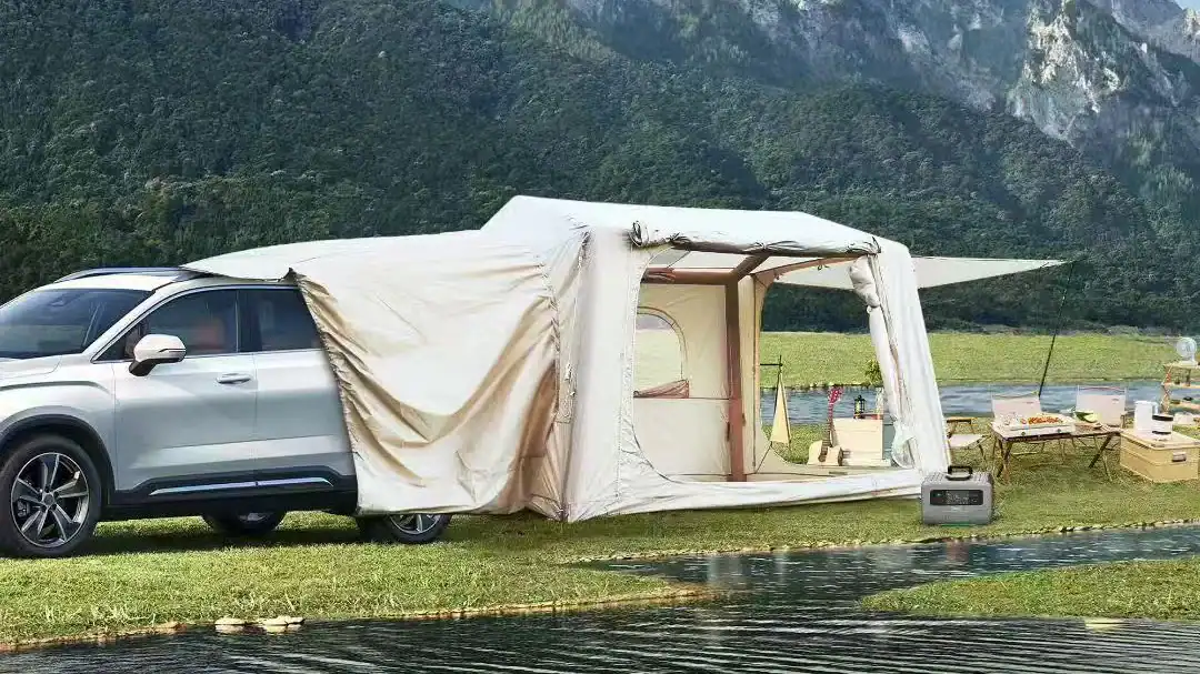 Car with attached tent for outdoor camping at Kelyland Outdoors.