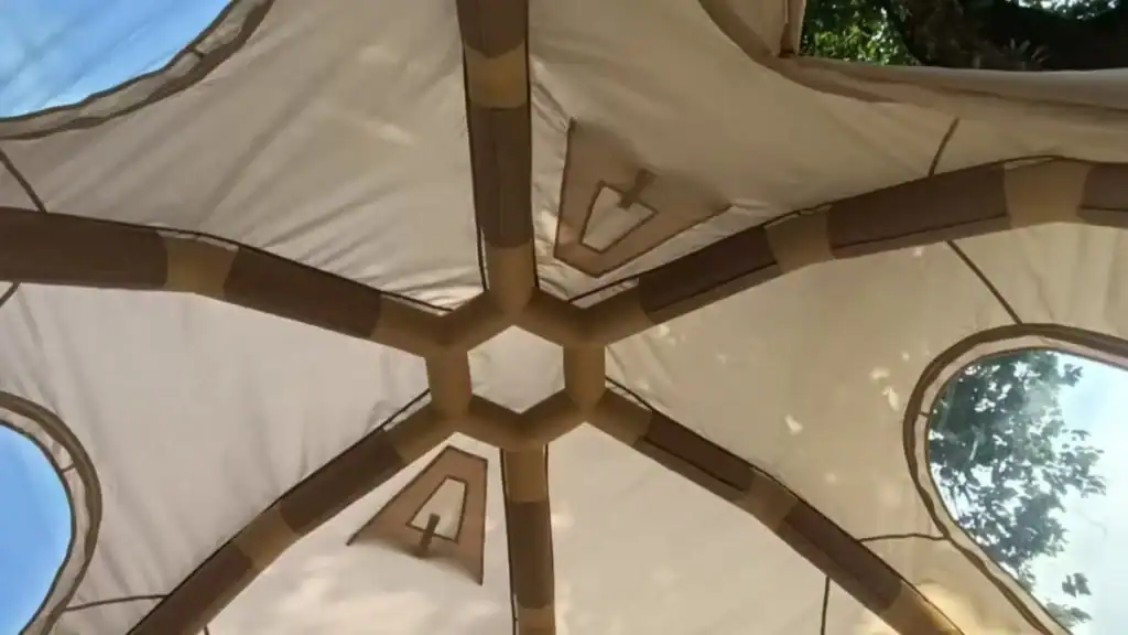 Best Inflatable Tents of 2026: Top 10 Air Beam Models Reviewed 3 Interior view of a camping tent roof showing its frame and fabric design, with a clear view of the overhead poles and fabric joints.