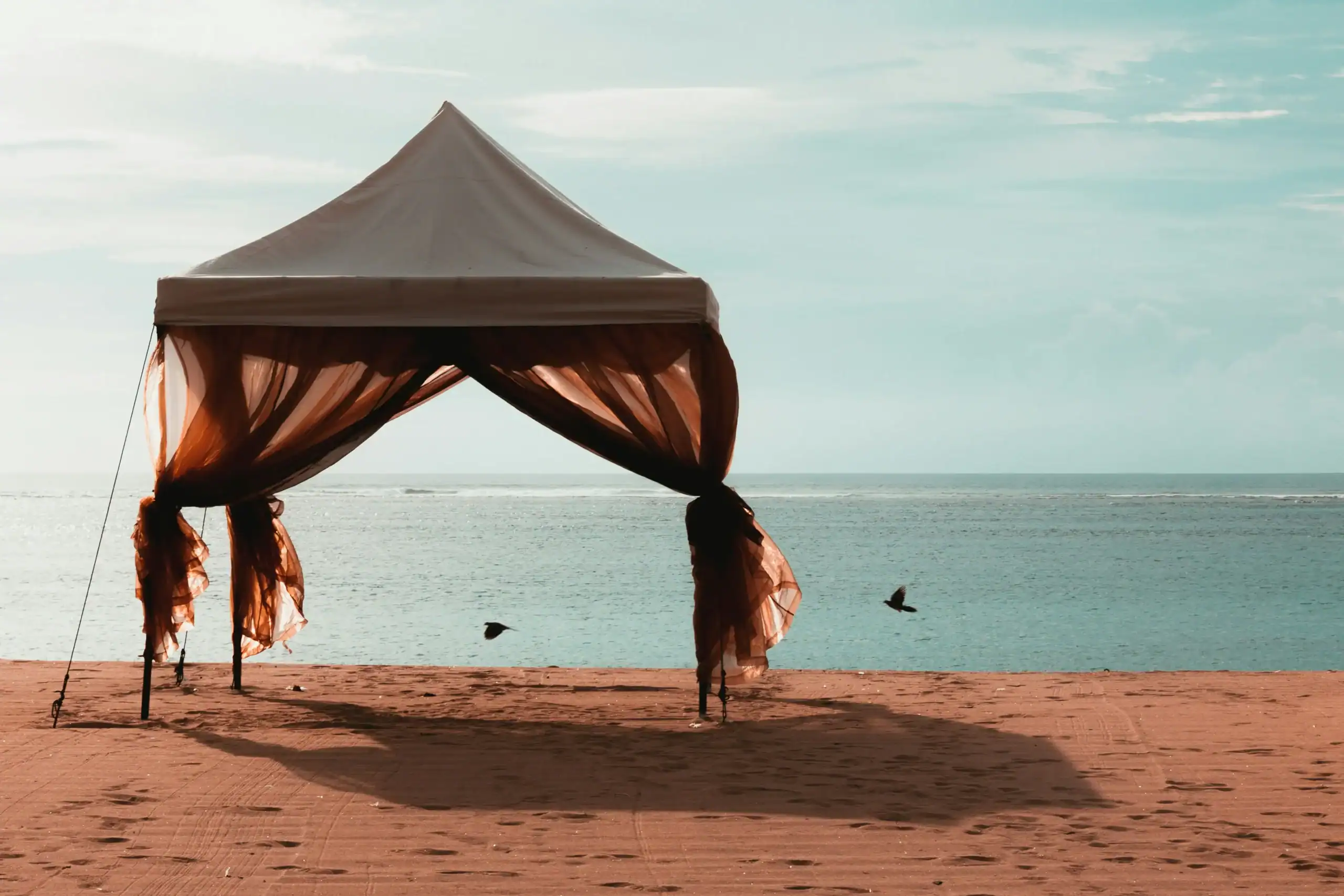Outdoor beach tent for relaxing by the sea with ocean views.