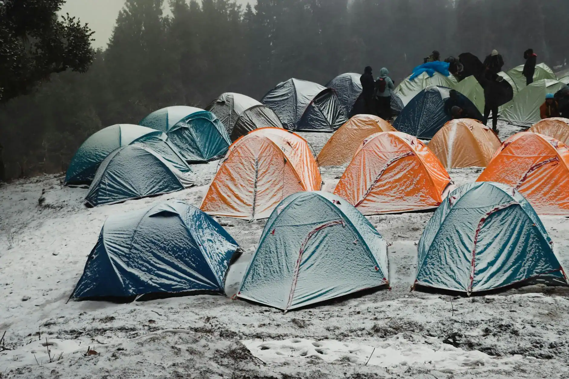 Tent Fly Water Pooling Fix: Cut Returns with Setup Order 20 Camping tents on a rainy outdoor landscape.