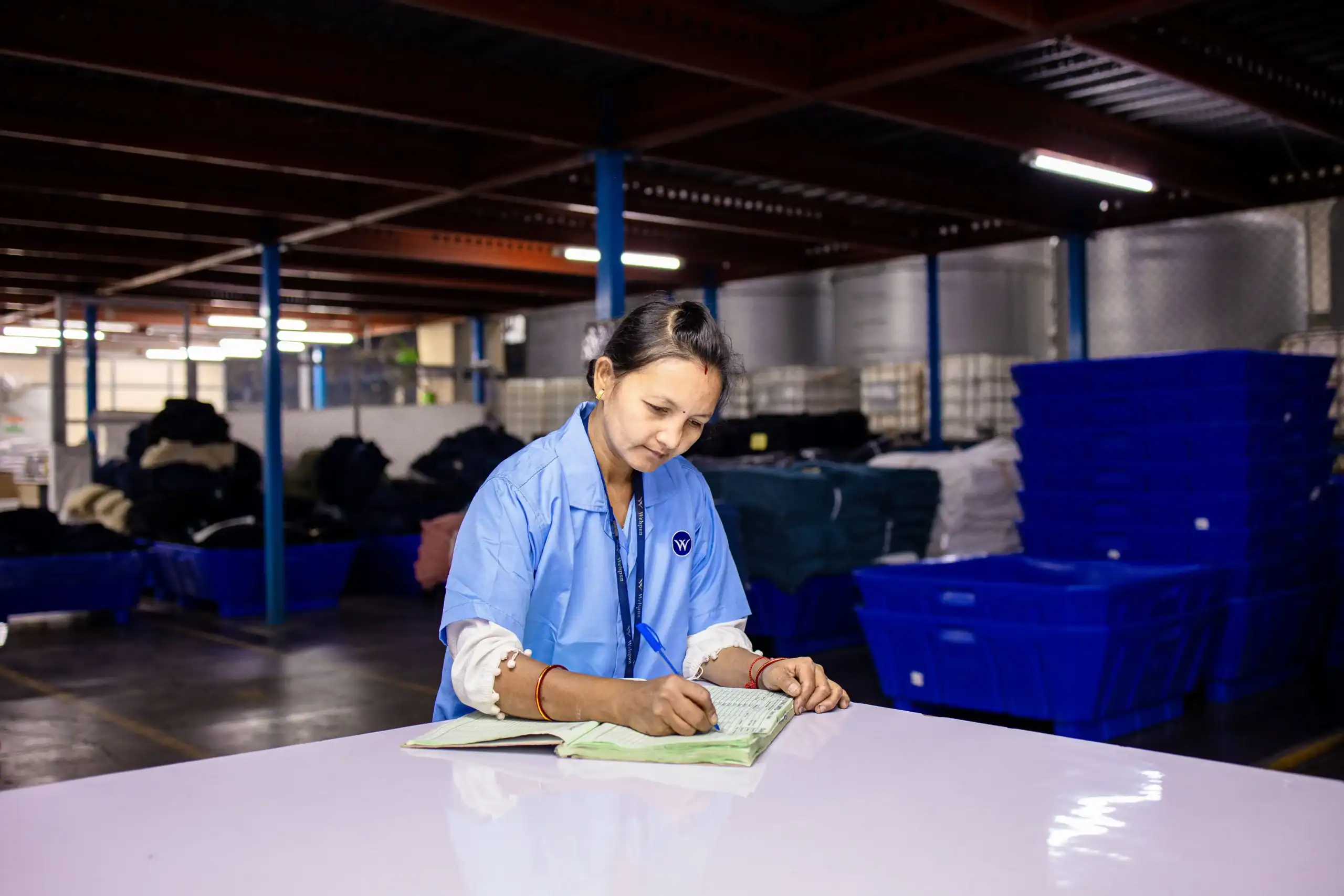 China Outdoor Factory Vetting Checklist: Avoid $15k Losses 5 A Kelyland Outdoors team member reviews product specifications at a warehouse desk, illustrating our OEM Sourcing & Manufacturing capabilities. The scene underscores our end-to-end ODM/OEM service for outdoor camping gear and the global supplier network we leverage.