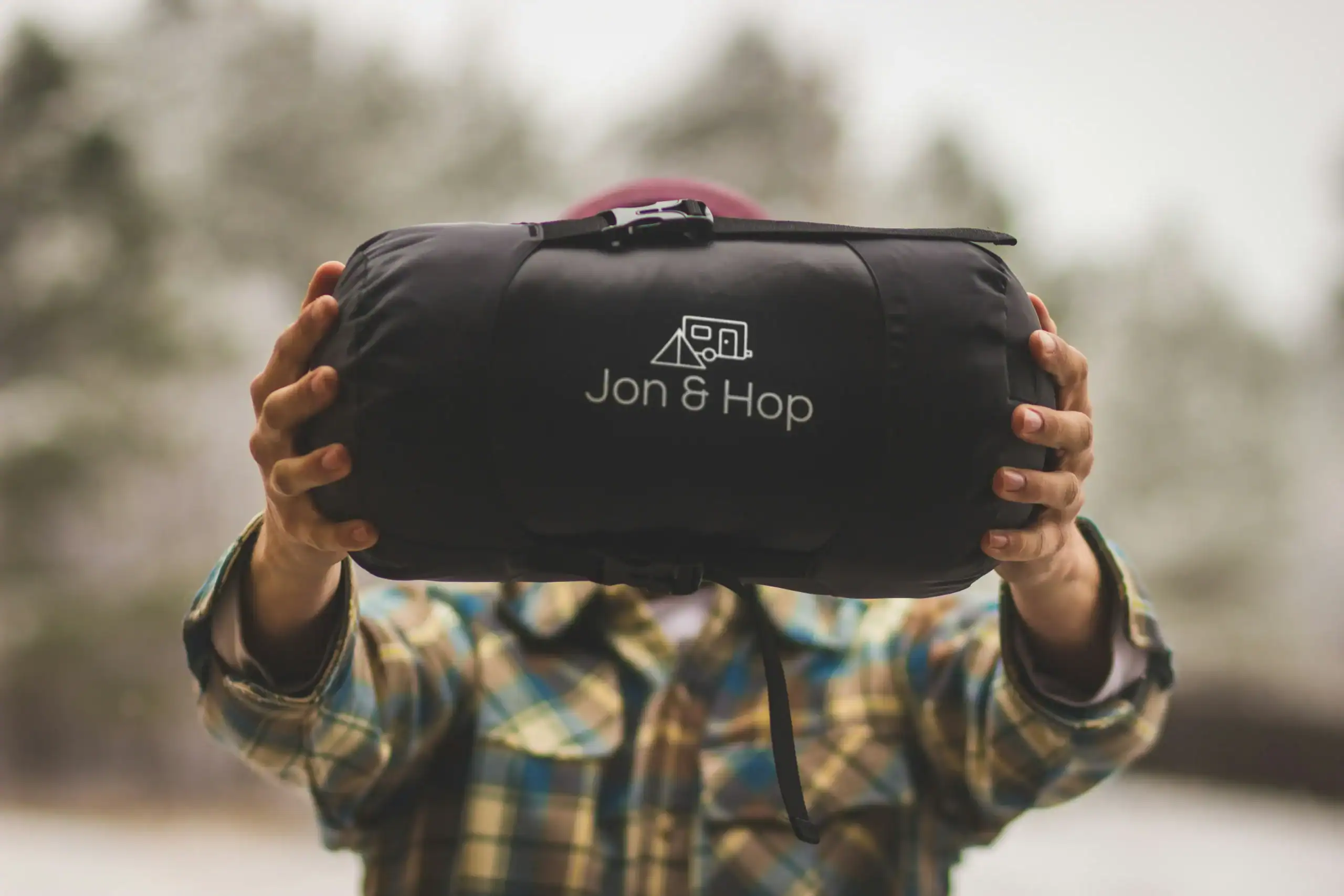 Outdoor gear bag with Jon & Hop logo for camping and hiking adventures.