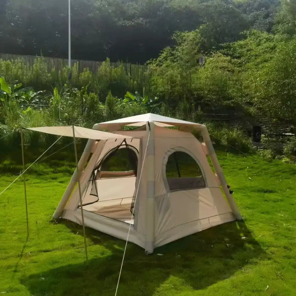 Family camping tent set up in lush green outdoor area with trees and grass.