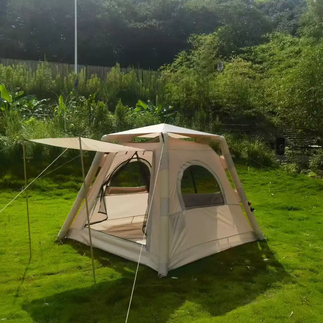 Family camping tent set up in lush green outdoor area with trees and grass.