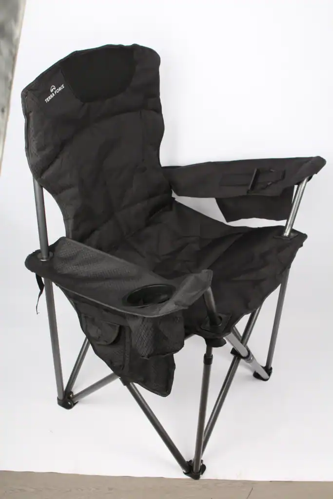 Black portable camping chair with cup holder and armrest for outdoor activities.