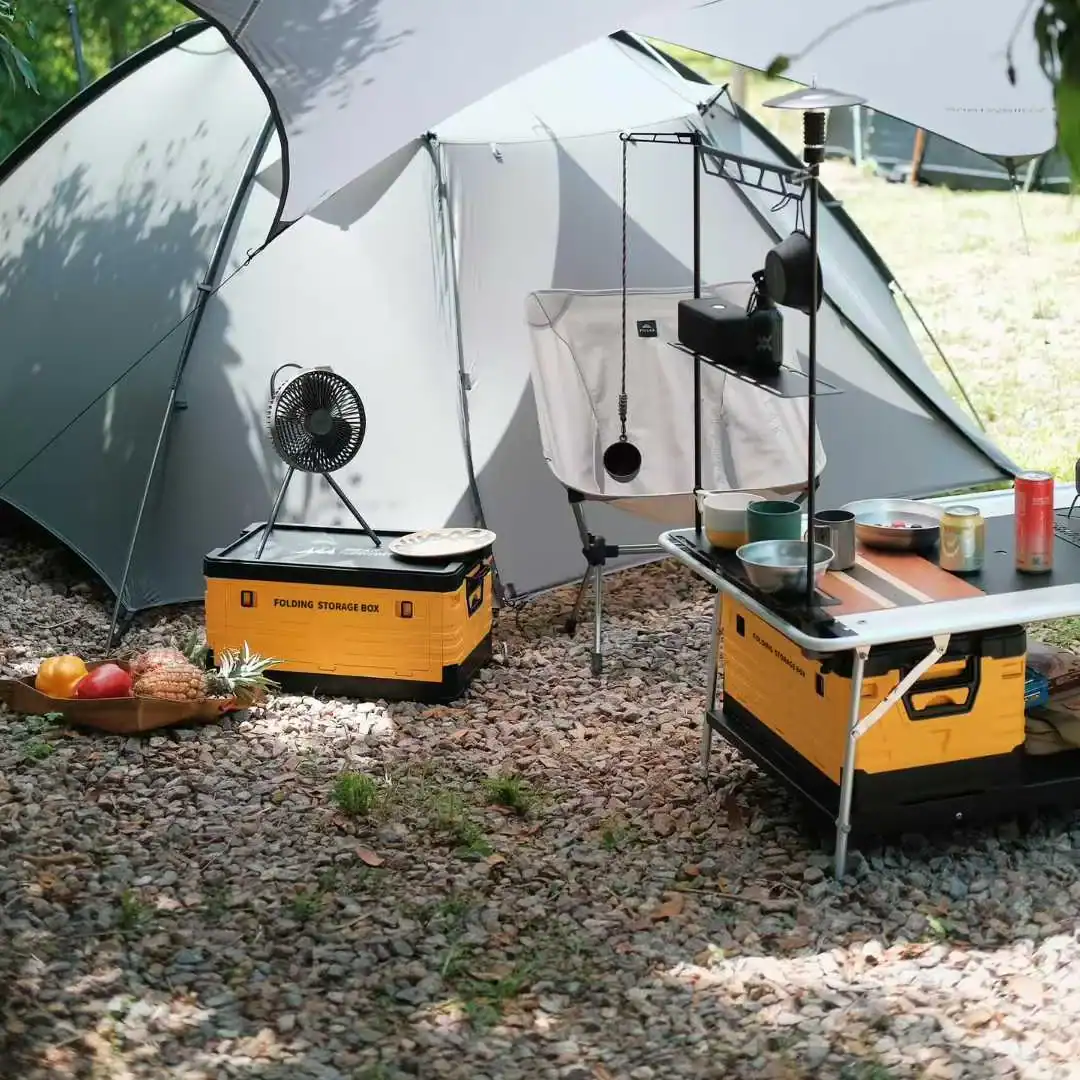 Camping setup with tent, table, and cooking gear outdoors at Kelyland Outdoors.
