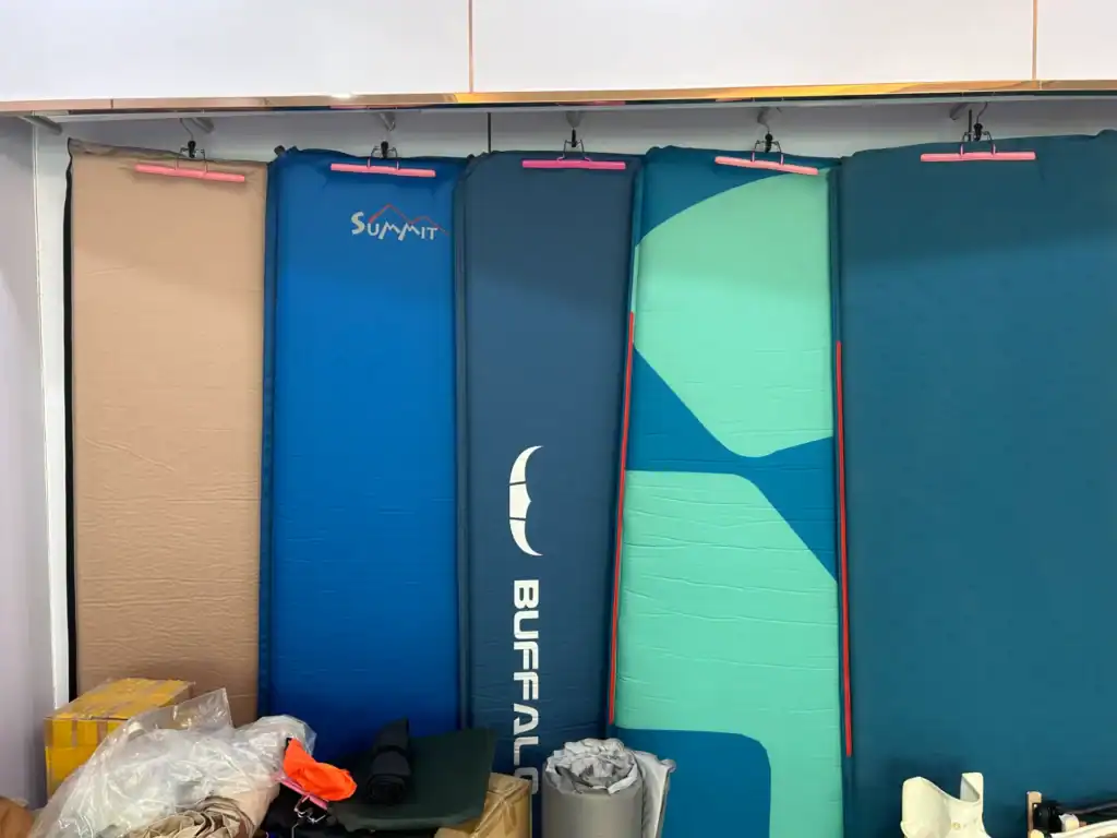 Air Mattress Leaks: 5 Hidden Weld Failures & Fixes 3 Collection of colorful stand-up paddleboards in a shop display.