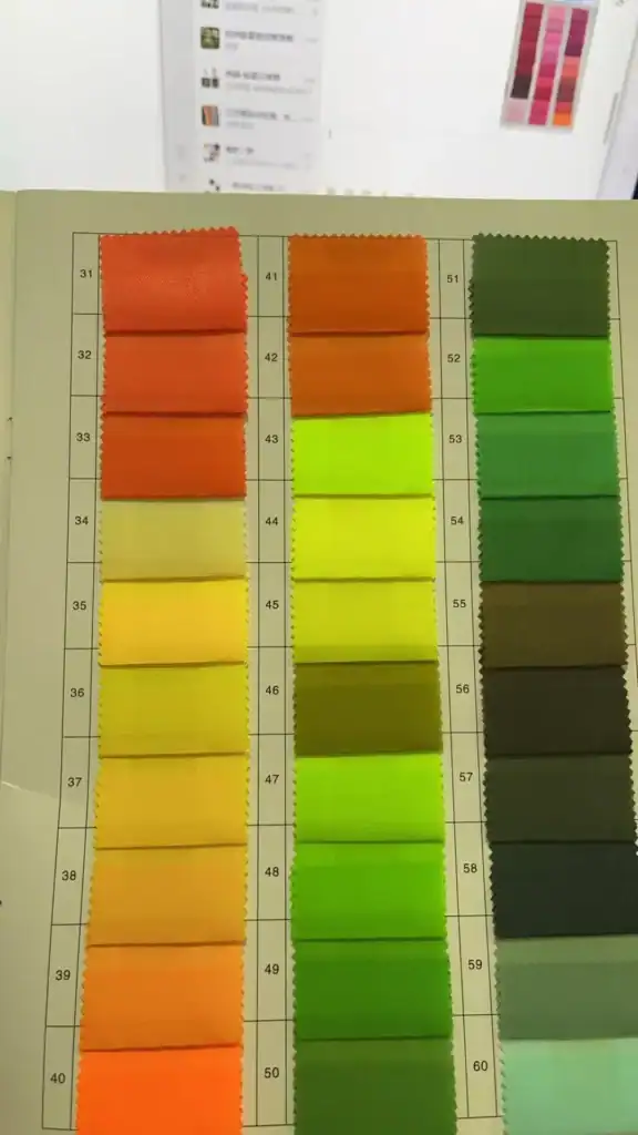 Custom Inflatable Tents TPU Blends Quality Control Guide 3 A fabric color sample chart displaying orange, yellow, green, and neutral swatches with numbered labels for textile selection.