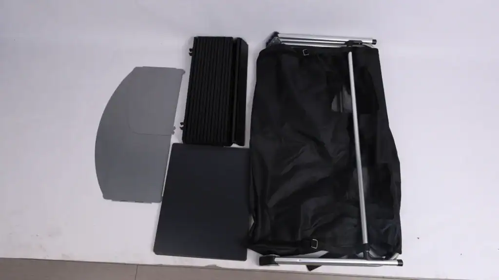 Disassembled portable outdoor camping or hiking gear on white surface.