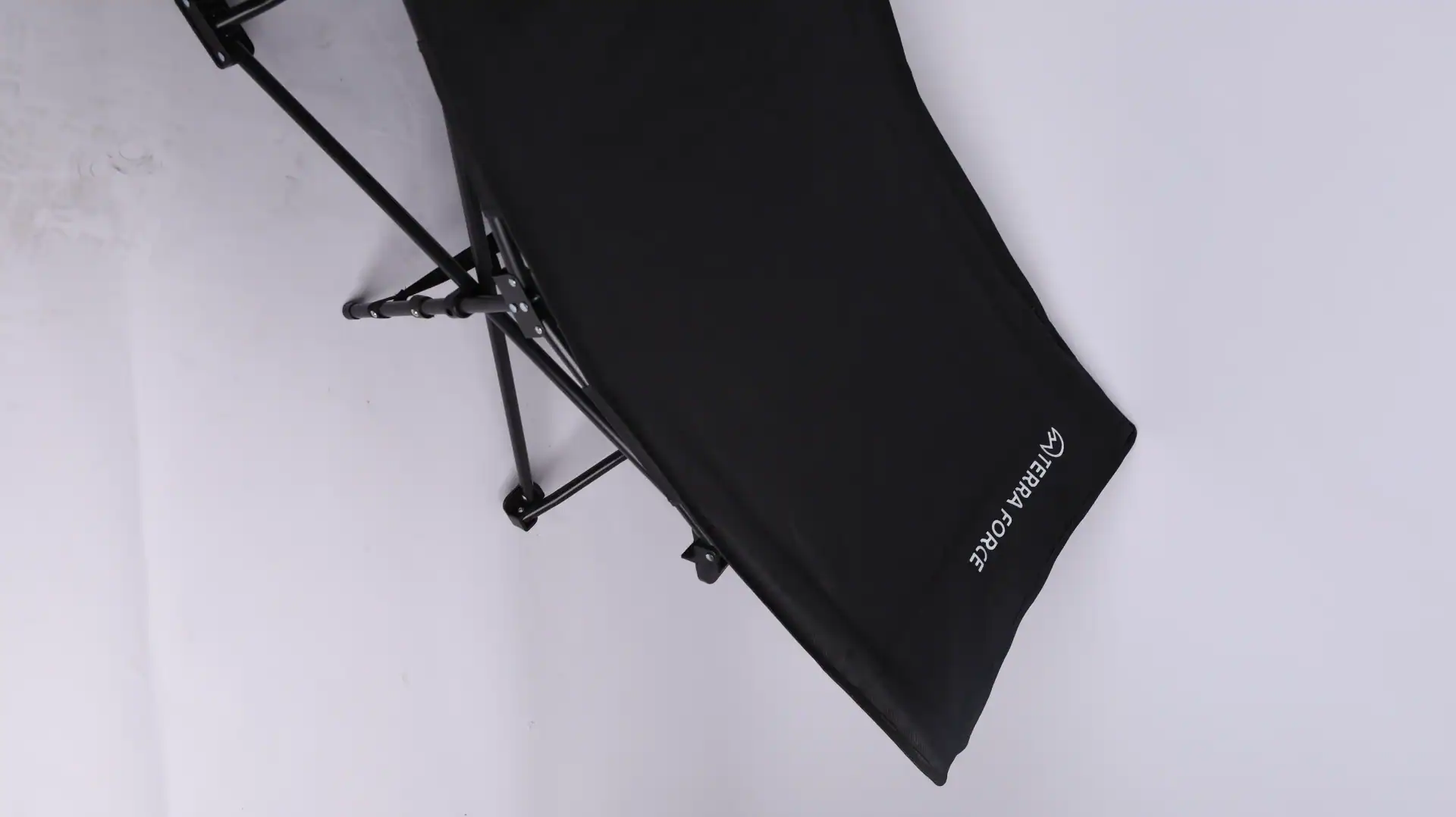 Folding black camping chair with sturdy metal frame and Terra Force branding, placed against a plain white background.
