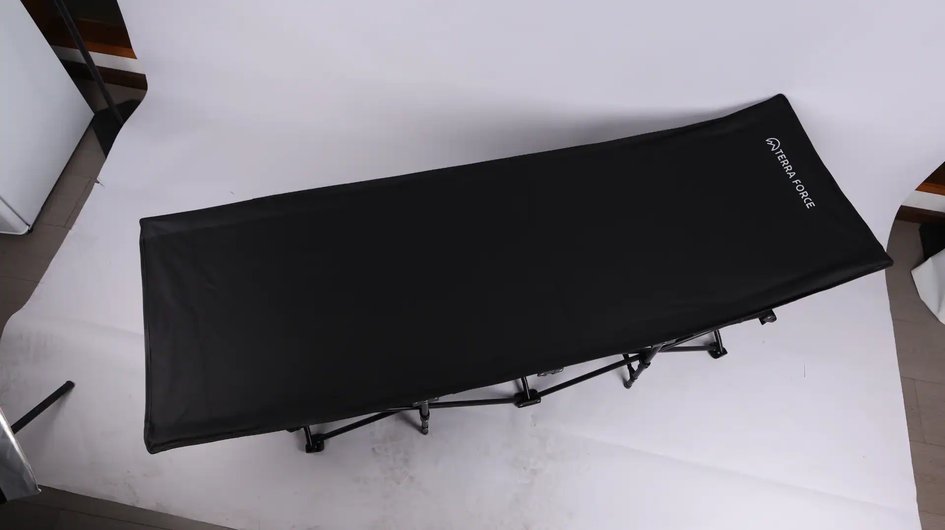 Drop-Stitch Air Mattress Buyers Guide: Cut Leak Returns 32 Black folding camping cot featuring a durable metal frame and Terra Force branding, set against a light studio backdrop.