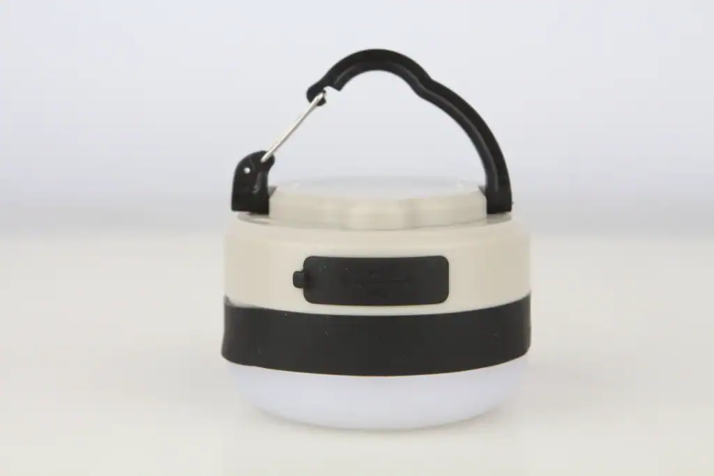 Portable camping lantern with handle for outdoor activities.