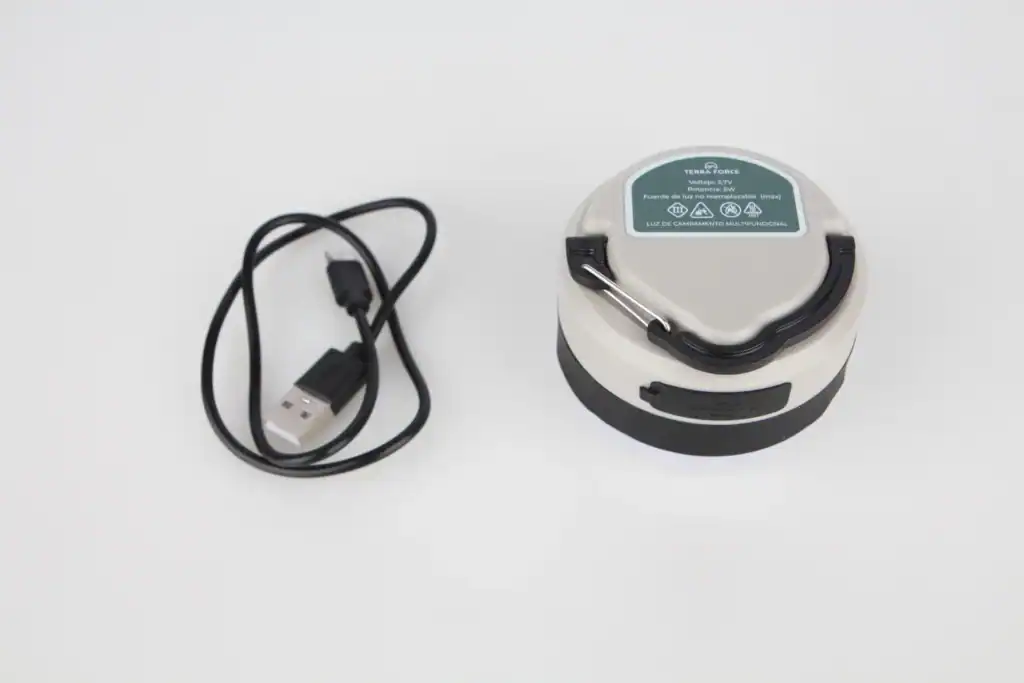 Camping Lights Buyers Guide: Types, Lumens, Battery Life & Certifications 6 Robot vacuum cleaner with charging dock and USB cable on white background.