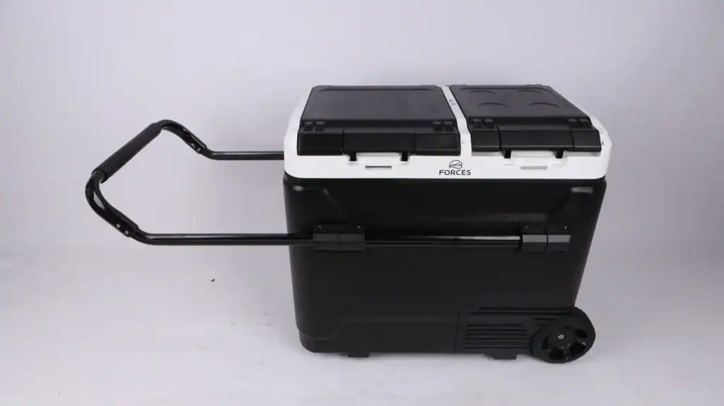 Portable cooler with wheels and handle for outdoor activities.