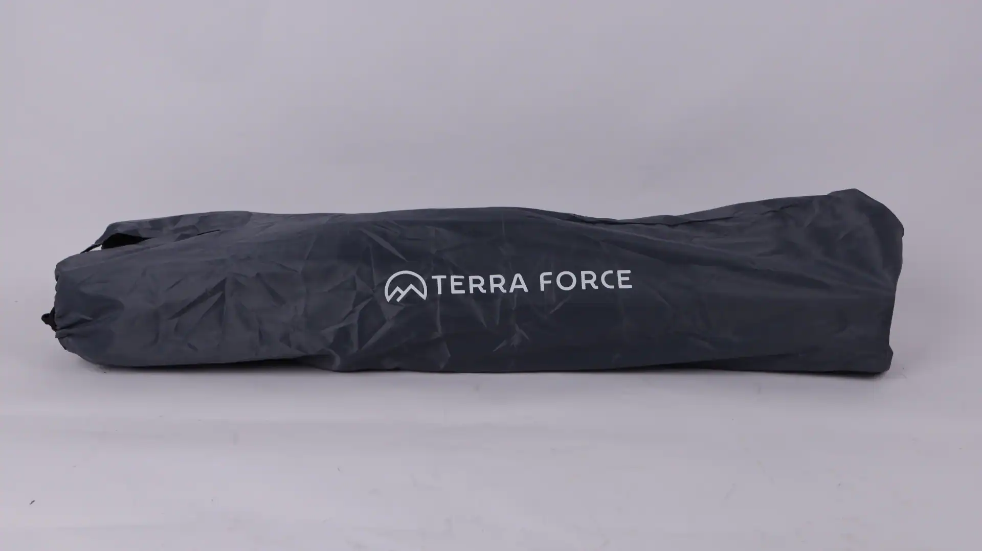Dark gray Terra Force camping gear bag with crinkled fabric on a plain light background, showcasing the logo.