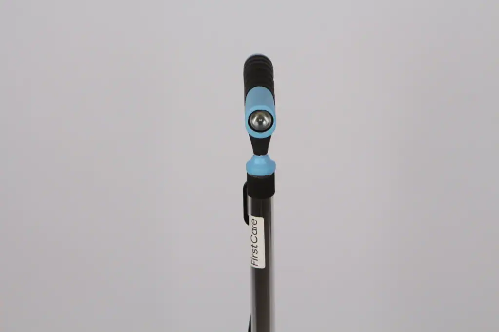 Adjustable walking stick handle with a built-in LED light, featuring a blue and black design on a silver shaft, branded as First Care.